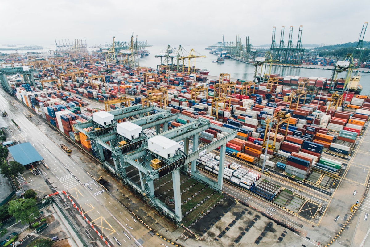 Aerial view of blue shipping containers stacked at a container terminal