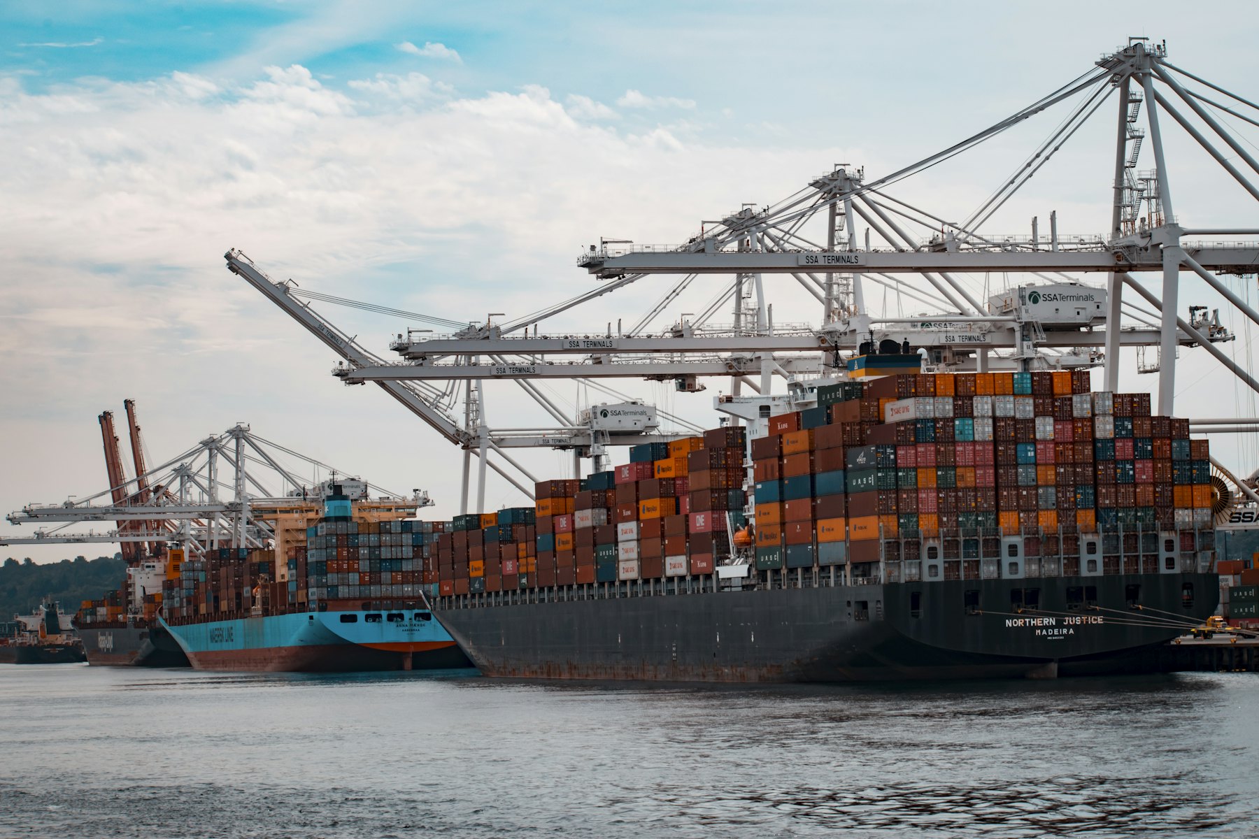 Gantry cranes loading containers onto a ship at a container terminal